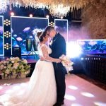 pexels-photo-32142660-32142660 Bride and groom share a romantic dance under beautiful floral decorations.